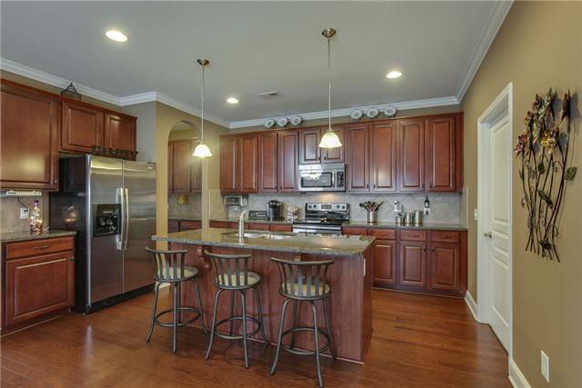 369 Truman Road West Franklin, TN 37064 - Photo 5 of 20 KITCHEN FEATURES SS APPL WITH SMOOTH COOKTOP & SINGLE OVEN, GRANITE, TILE BACKSPLASH, ISLAND WITH SINK & BAR STOOL SEATING, PENDANT & RECESSED LIGHTS