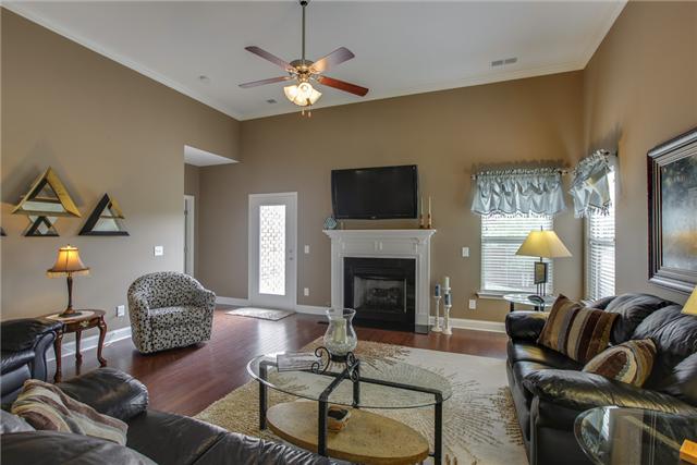 369 Truman Road West Franklin, TN 37064 - Photo 8 of 20 THE COZY LIVING ROOM FEATURES 12' CEILINGS, CEILING FAN, GAS LOG FIREPLACE W/ELECTRIC START & GRANITE SURROUND, HARDWOODS, CROWN, 2" BLINDS AND ARCHED ENTRIES TO BREAKFAST/KITCHEN AREA