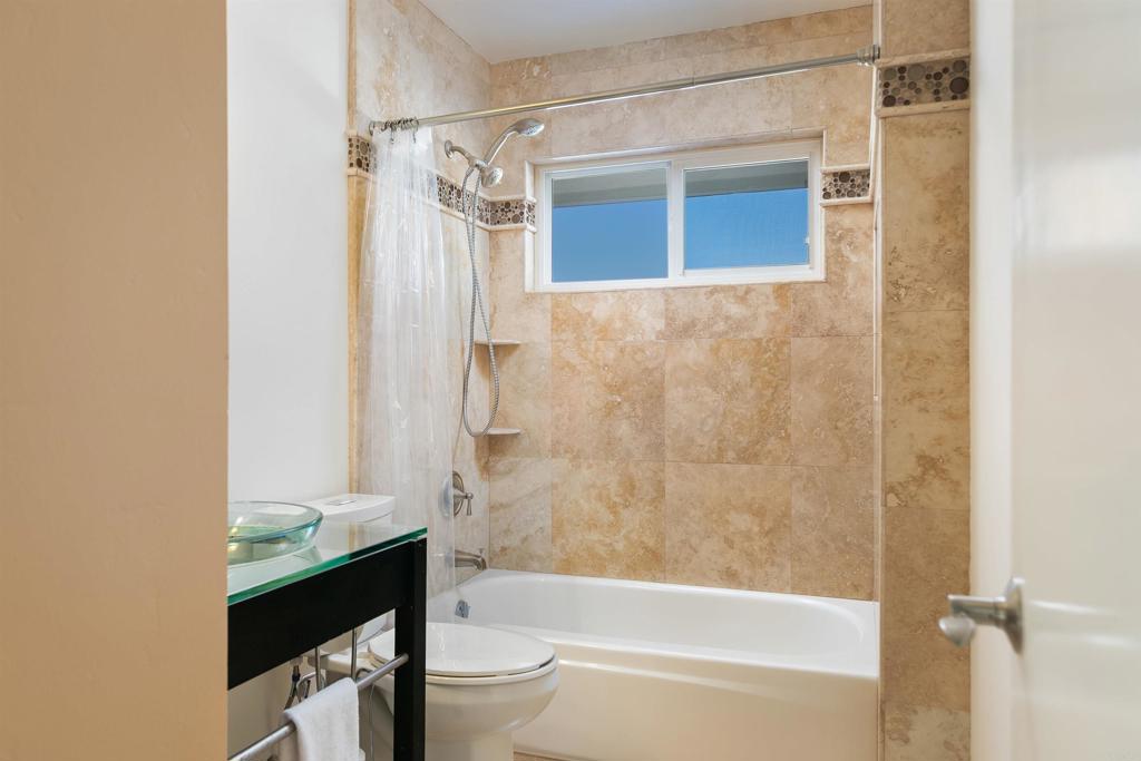 2252 Soledad Rancho Road San Diego, CA 92109 - Photo 24 of 39 a bathroom with a granite countertop bathtub shower sink vanity and toilet