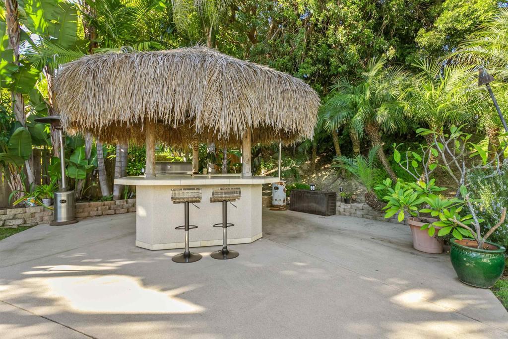 2252 Soledad Rancho Road San Diego, CA 92109 - Photo 32 of 39 a view of a patio with table and chairs potted plants