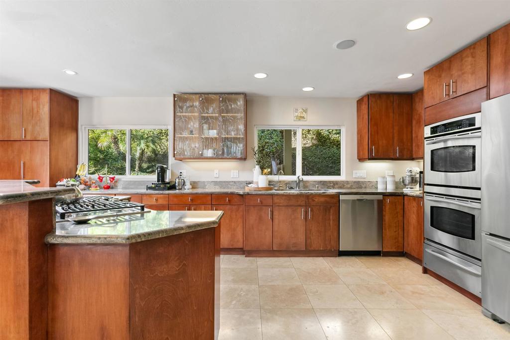 2252 Soledad Rancho Road San Diego, CA 92109 - Photo 6 of 39 a kitchen with stainless steel appliances granite countertop a sink stove and oven