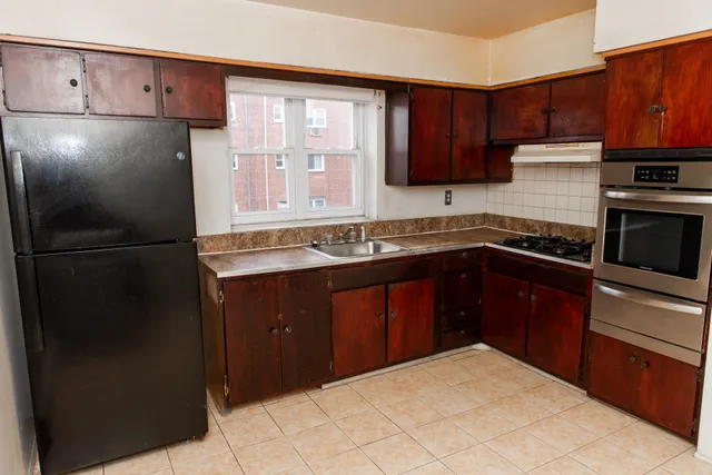 a kitchen with a refrigerator and a sink