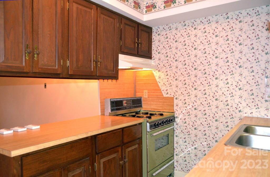 3508 Colony Road, Unit D Charlotte, NC 28211 - Photo 7 of 24 a kitchen with a sink a stove and a microwave