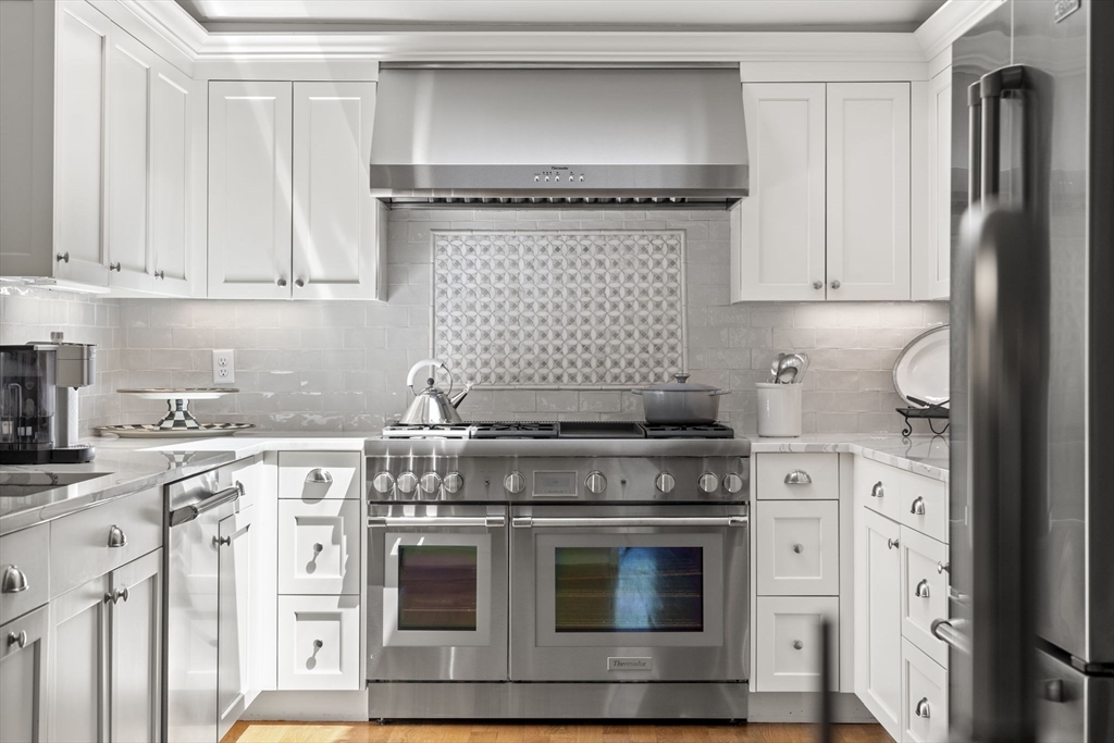 40 Morton Street Andover, MA 01810 - Photo 13 of 32 a kitchen with stainless steel appliances granite countertop a stove a refrigerator and a white cabinets