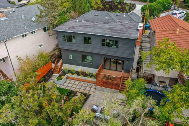 an aerial view of a house with a yard