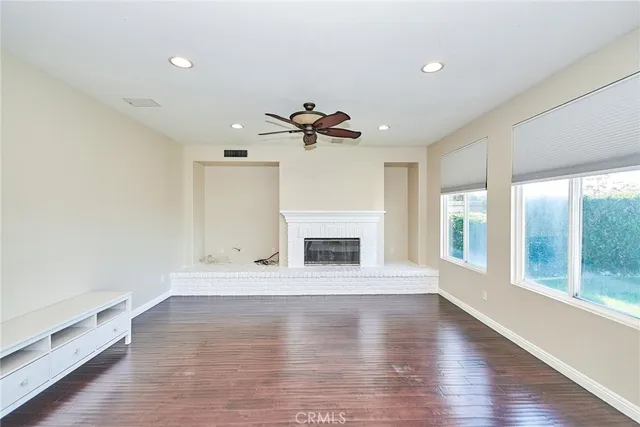 a kitchen with granite countertop a sink stove refrigerator and cabinets