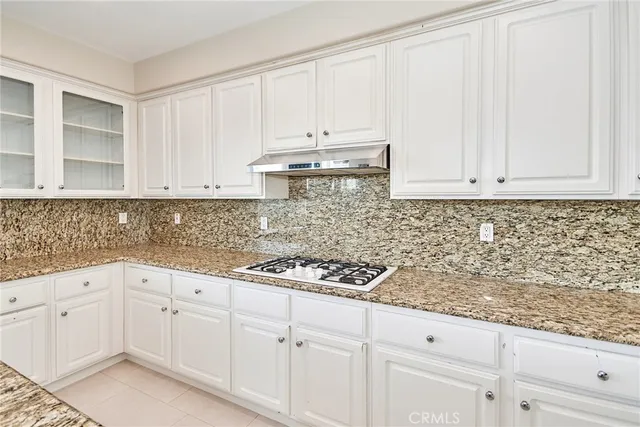 a large kitchen with stainless steel appliances granite countertop a large counter top and a stove