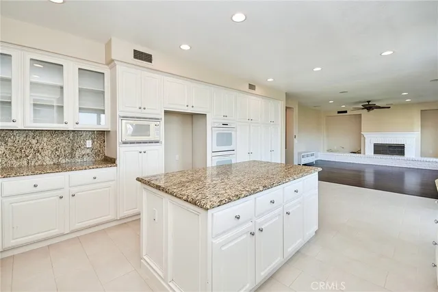 a view of empty room with wooden floor and windows