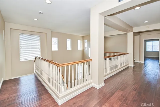 a view of a hallway with wooden floor