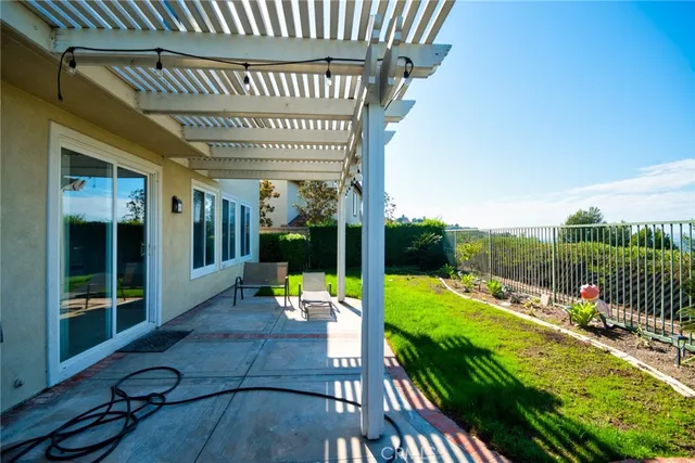 a view of a house with backyard sitting area and garden