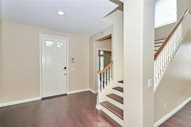 a view of an entryway with wooden floor and door