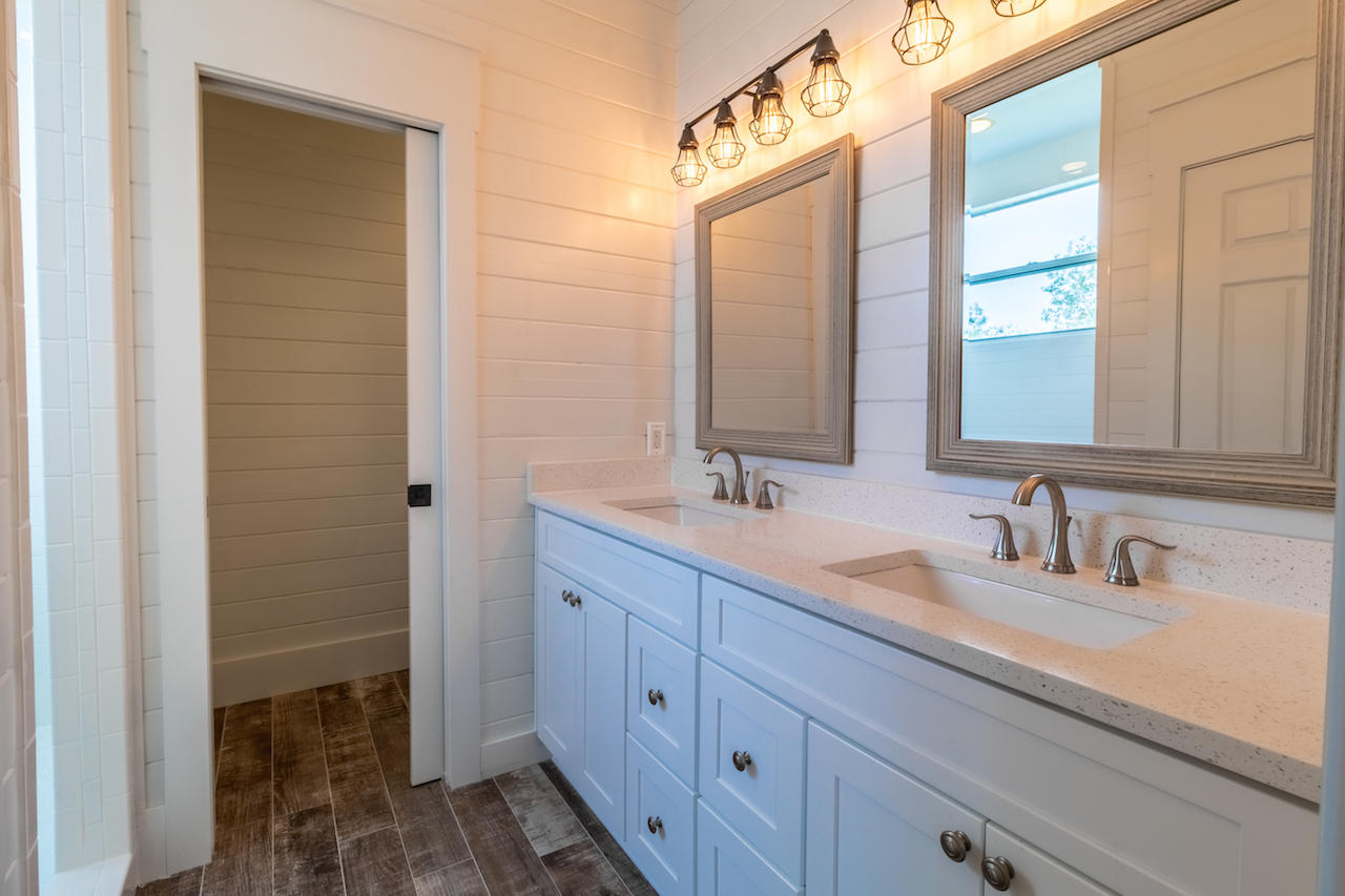 72 Carolyn Lane Santa Rosa Beach, FL 32459 - Photo 11 of 25 a bathroom with a double vanity sink and a mirror