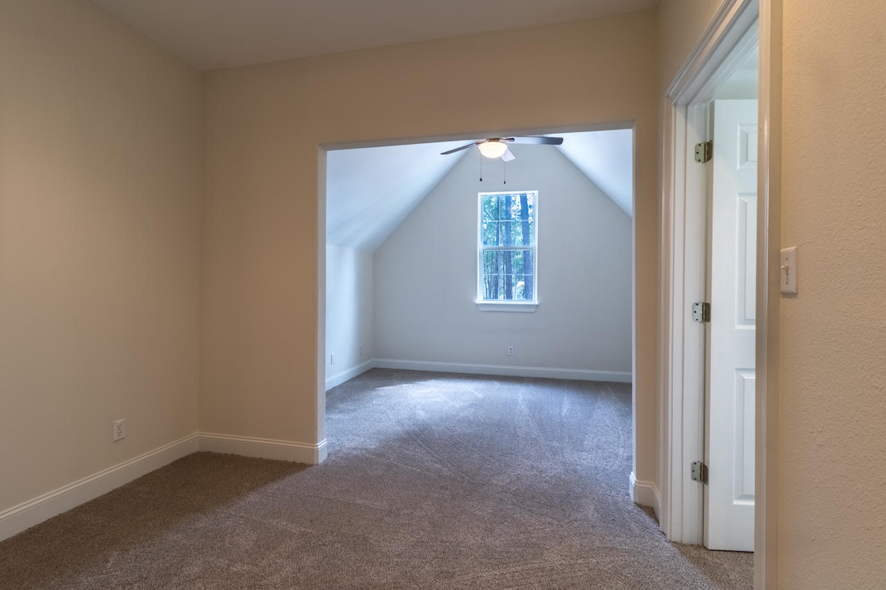 72 Carolyn Lane Santa Rosa Beach, FL 32459 - Photo 12 of 25 an empty room with a window and chandelier fan