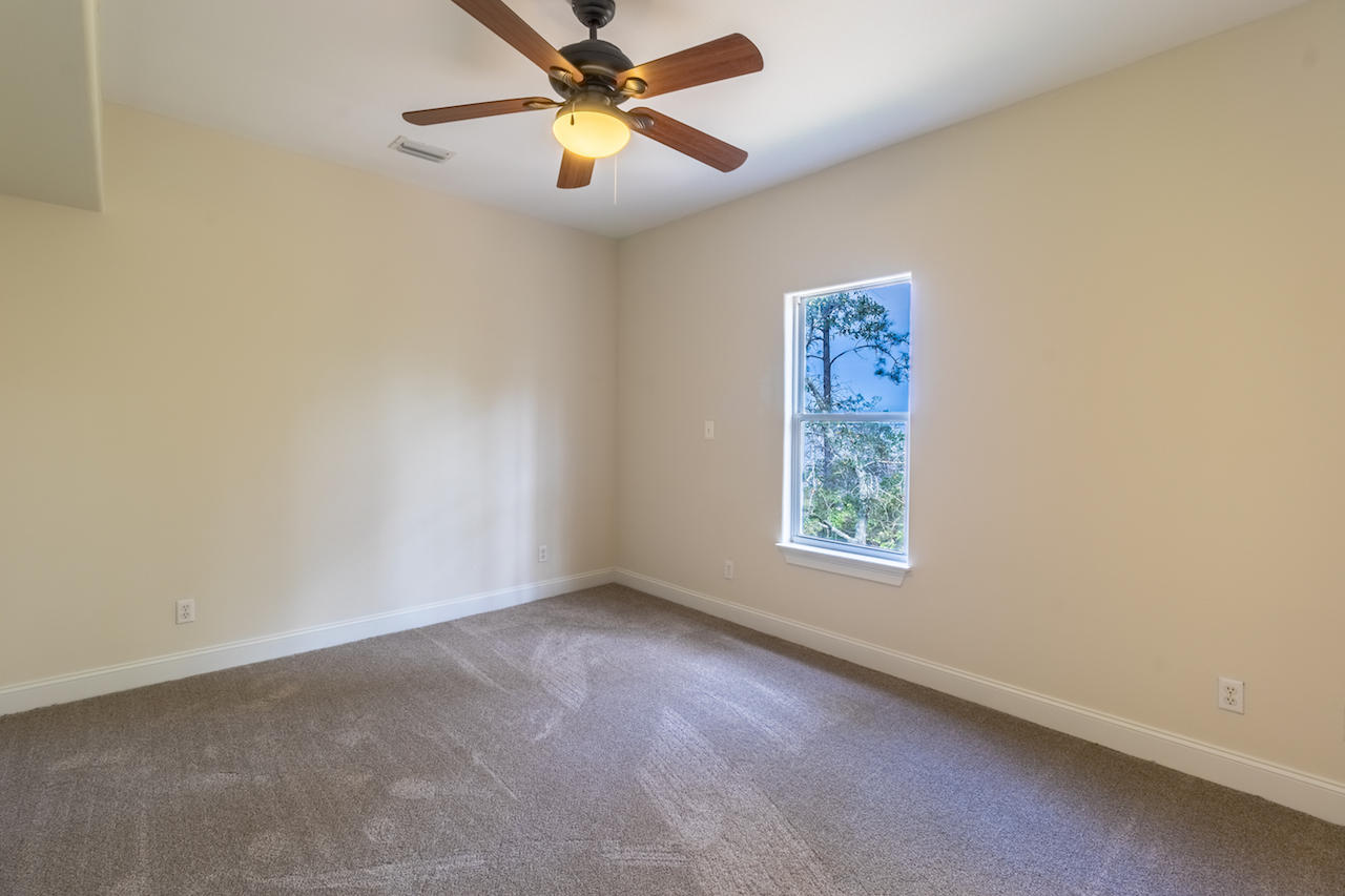 72 Carolyn Lane Santa Rosa Beach, FL 32459 - Photo 13 of 25 an empty room with a window and a fan