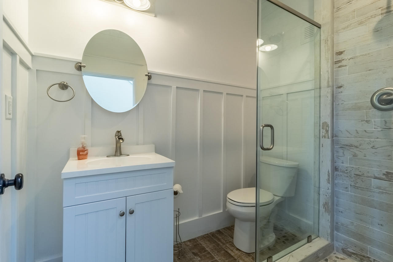 72 Carolyn Lane Santa Rosa Beach, FL 32459 - Photo 9 of 25 a bathroom with a toilet sink vanity granite and shower