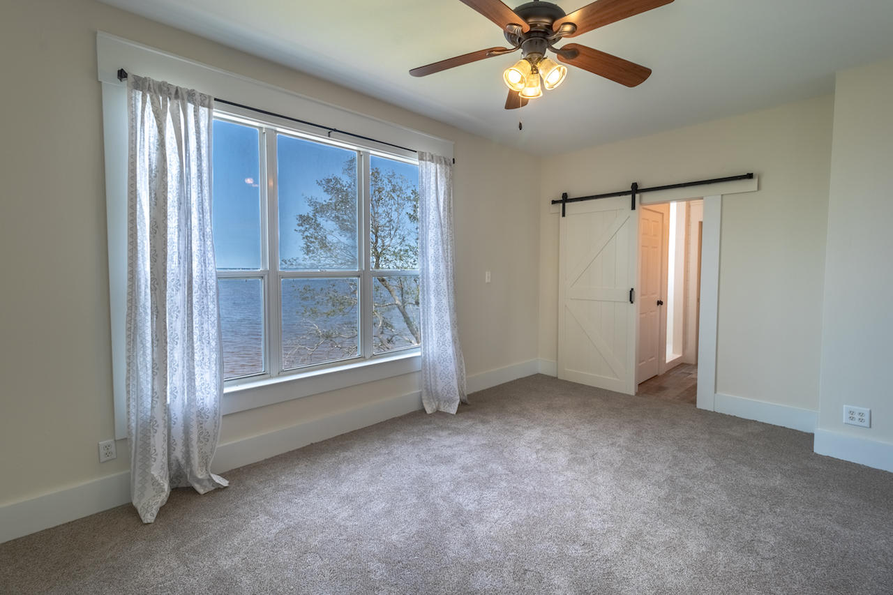 72 Carolyn Lane Santa Rosa Beach, FL 32459 - Photo 10 of 25 an empty room with windows and fan