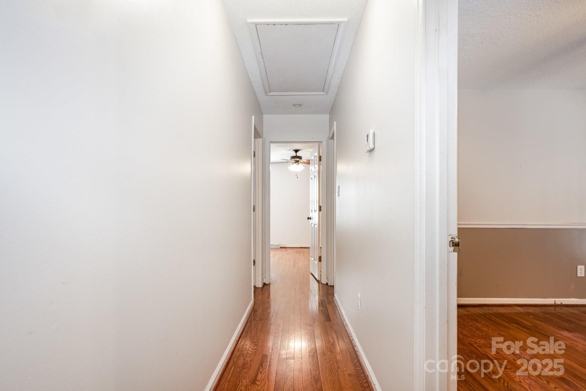 7615 Alexander Road Charlotte, NC 28270 - Photo 12 of 19 a view of a hallway with wooden floor