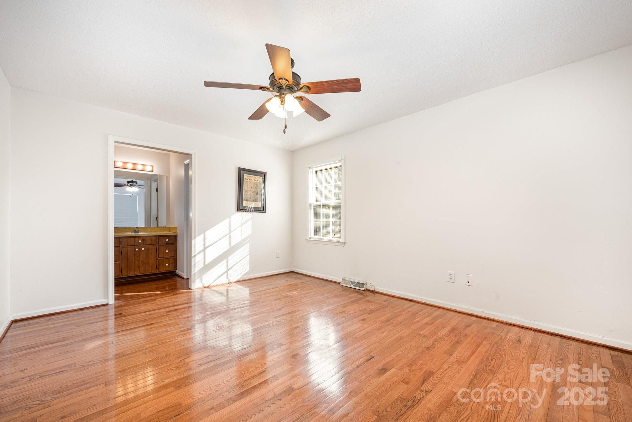 7615 Alexander Road Charlotte, NC 28270 - Photo 14 of 19 a view of empty room with wooden floor and fan