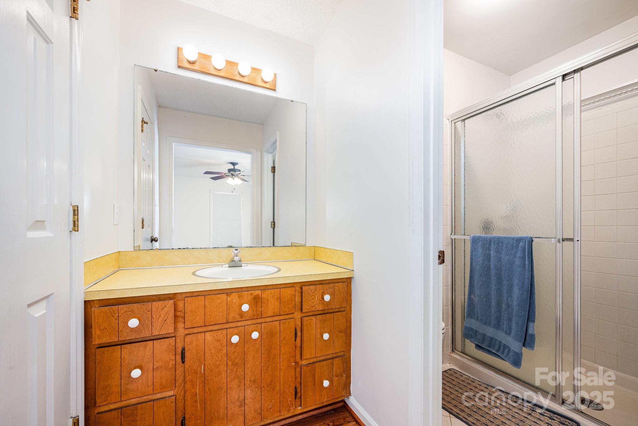 7615 Alexander Road Charlotte, NC 28270 - Photo 15 of 19 a bathroom with a granite countertop sink mirror and