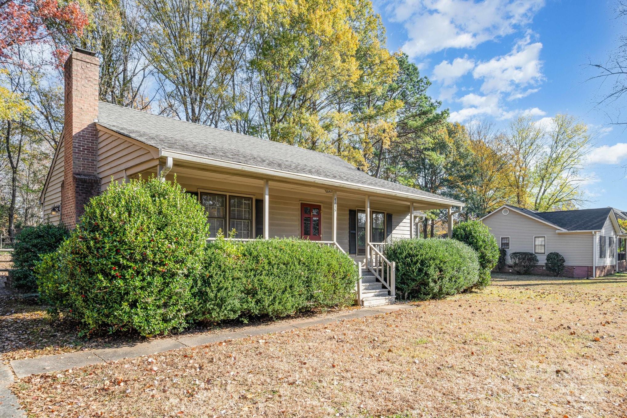 7615 Alexander Road Charlotte, NC 28270 - Photo 2 of 19 a front view of a house with a yard and potted plants
