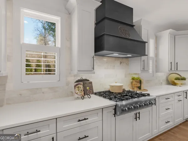 a kitchen with stainless steel appliances a stove and cabinets