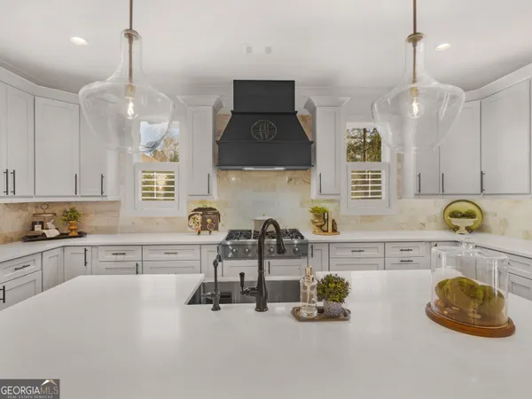 a kitchen with a sink cabinets and window