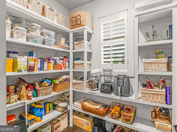 a hallway with cabinets and window