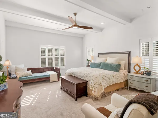 a bedroom with a large bed and a window