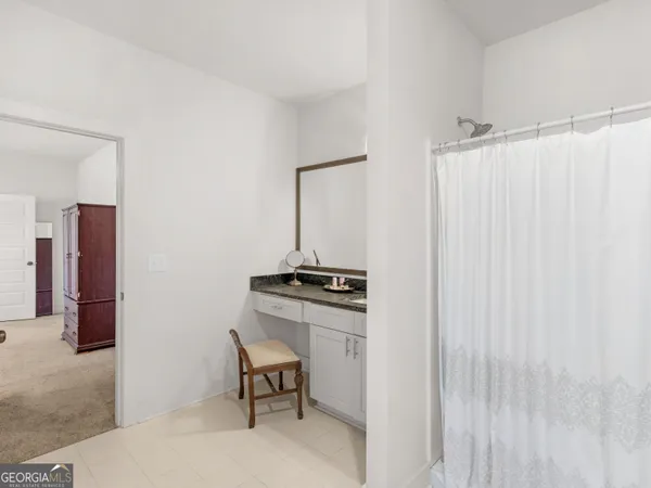 a bedroom with a bed chandelier and a window