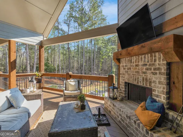 a living room with patio furniture and a floor to ceiling window