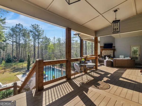 a living room with patio furniture and a floor to ceiling window