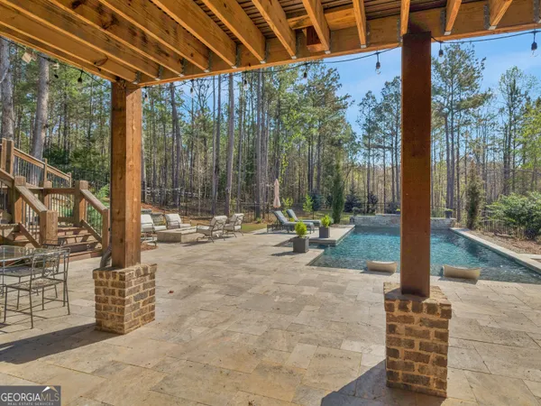 a view of patio with couches and a fire pit