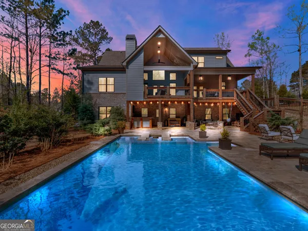 a view of a house with swimming pool and sitting area