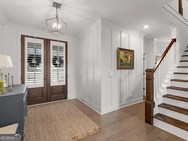 a view of a livingroom with wooden floor and stairs