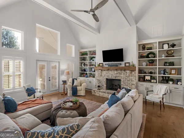 a living room with furniture a fireplace and a flat screen tv
