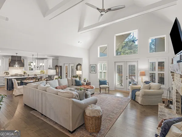 a living room with furniture large window and flat screen tv