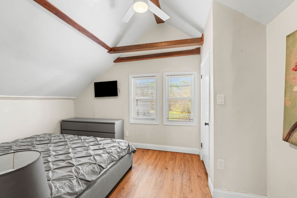 271 Broadway Haverhill, MA 01832 - Photo 28 of 41 a bedroom with a bed and a flat screen tv