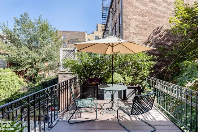 a view of a chair and tables in the balcony