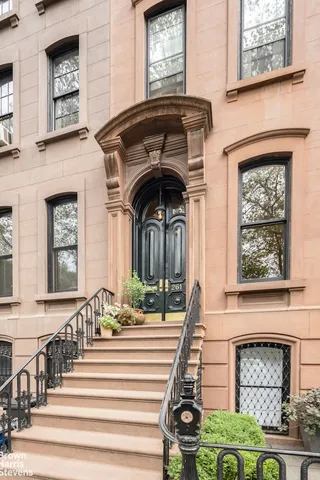 a front view of a house with a fountain