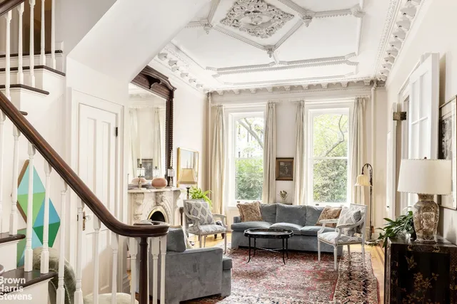 a living room with furniture and large windows