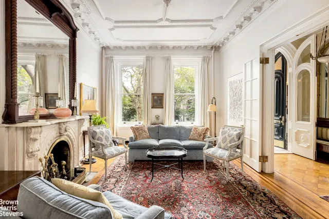 a living room with furniture fireplace and a large window