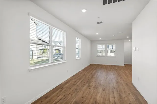 a view of an empty room and a window