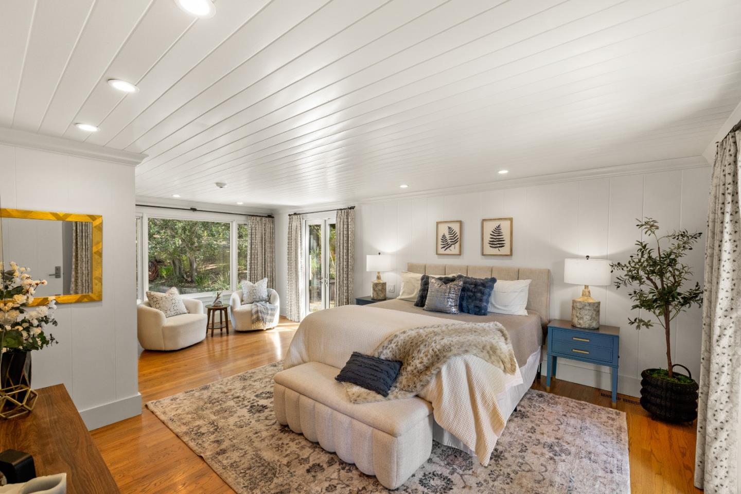 58 La Rancheria Carmel Valley, CA 93924 - Photo 12 of 36 a bedroom with a large bed and a potted plant