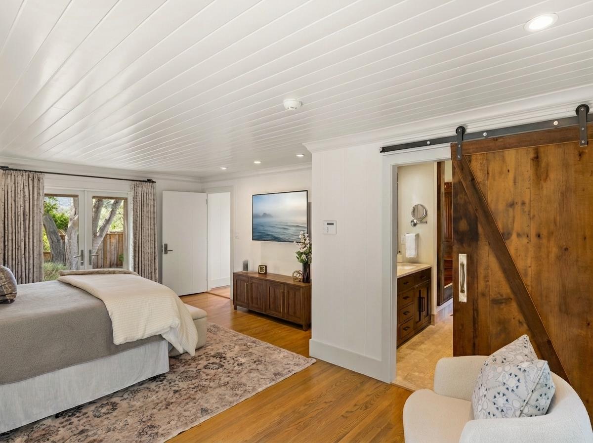 58 La Rancheria Carmel Valley, CA 93924 - Photo 14 of 36 a bedroom with a bed and a couch