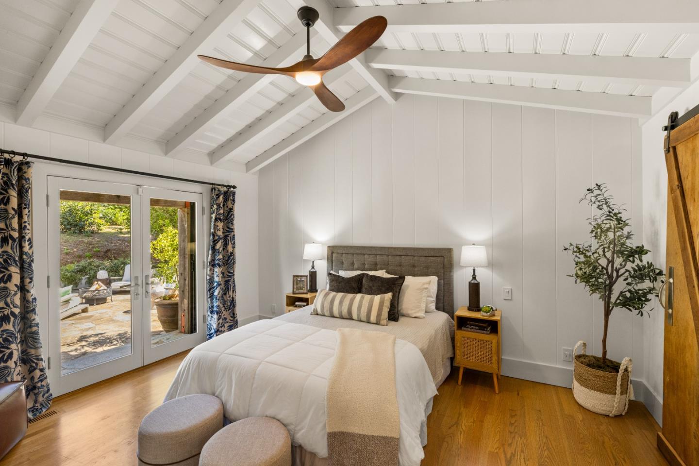 58 La Rancheria Carmel Valley, CA 93924 - Photo 18 of 36 a bedroom with a bed and a potted plant