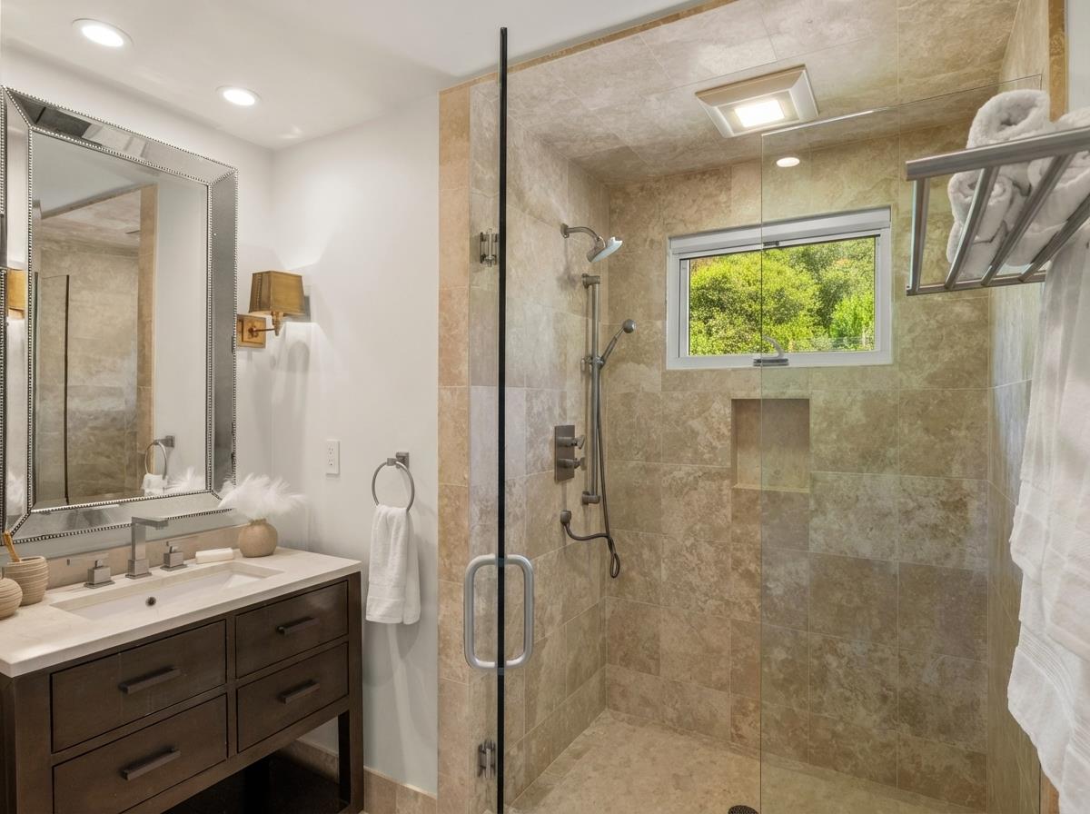 58 La Rancheria Carmel Valley, CA 93924 - Photo 19 of 36 a bathroom with a double vanity sink mirror and shower