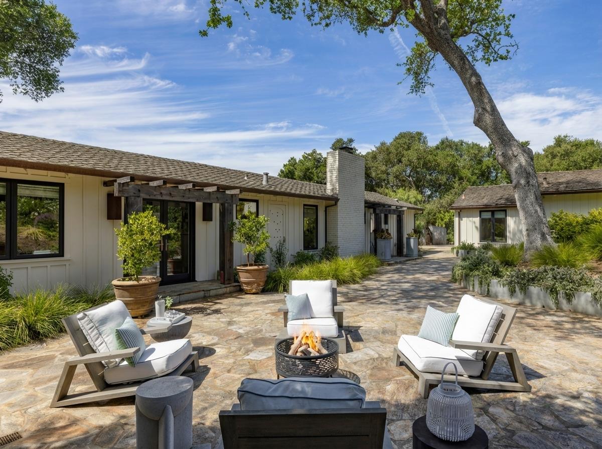 58 La Rancheria Carmel Valley, CA 93924 - Photo 2 of 36 a view of a patio with table and chairs potted plants and a large tree