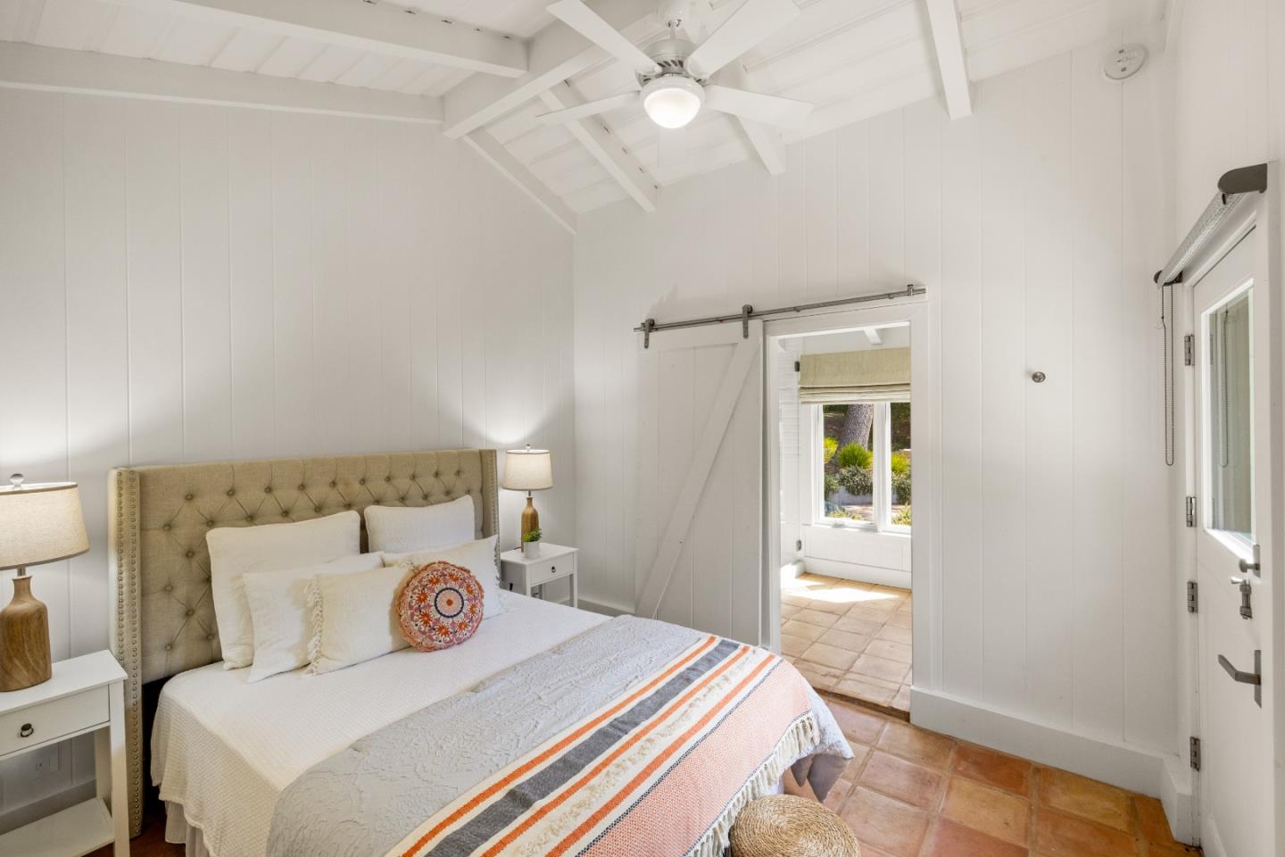 58 La Rancheria Carmel Valley, CA 93924 - Photo 21 of 36 a bedroom with a bed and a chandelier