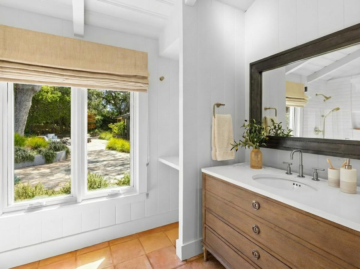 58 La Rancheria Carmel Valley, CA 93924 - Photo 22 of 36 a bathroom with a double vanity sink window and a mirror