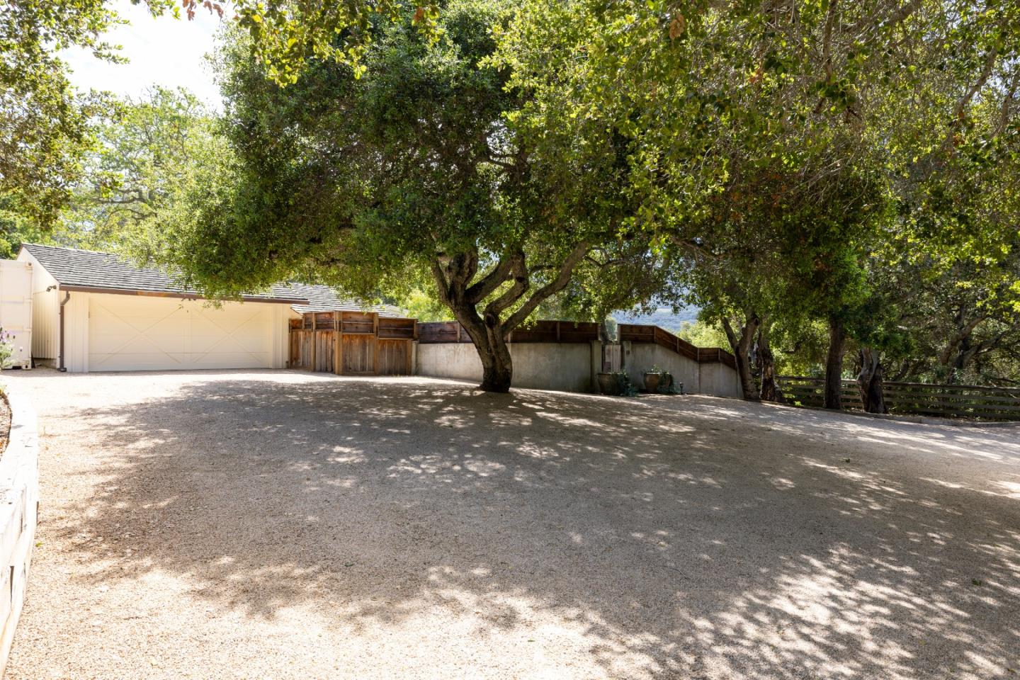 58 La Rancheria Carmel Valley, CA 93924 - Photo 31 of 36 a front view of a house with a yard and a garage